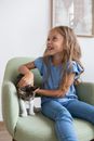 Smiling Girl on Armchair with Cat