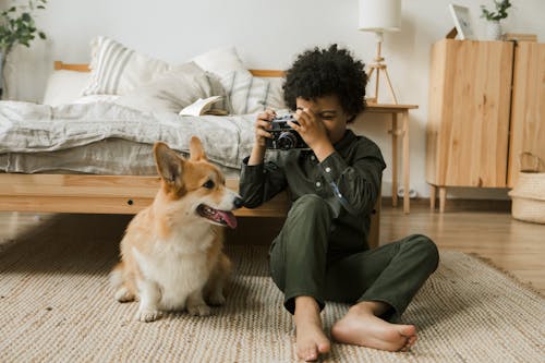 Boy Taking Picture of Dog on Vintage Camera