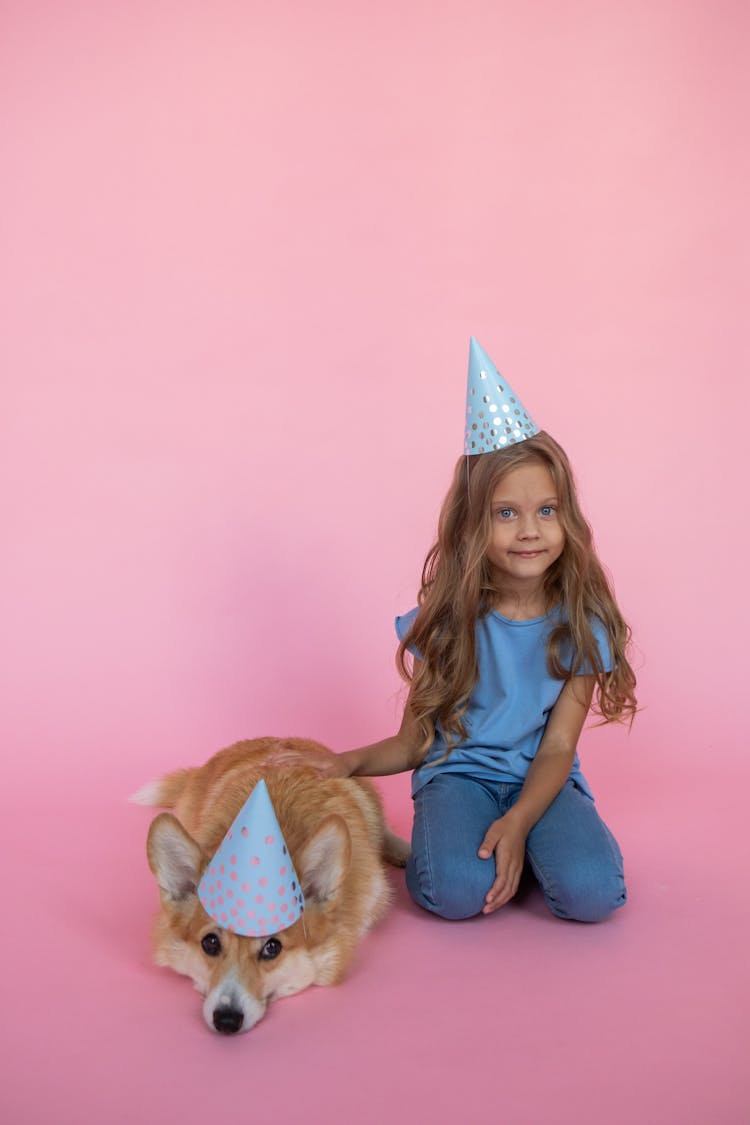 Girl And Dog In Birthday Hat