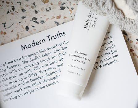 White skincare tube with text laid on an open book, featuring calm design elements.