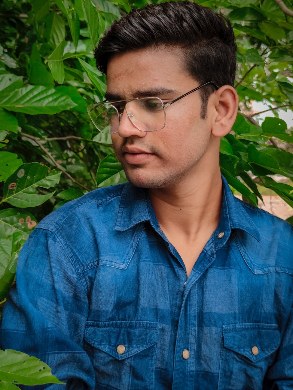 Man in Blue Denim Button Up Shirt Wearing Eyeglasses · Free Stock Photo