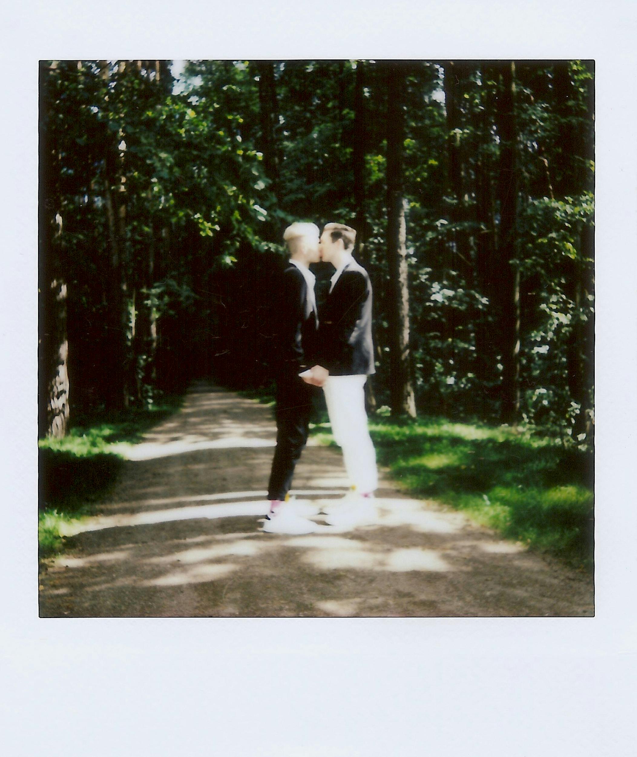 polaroid photo of a couple kissing