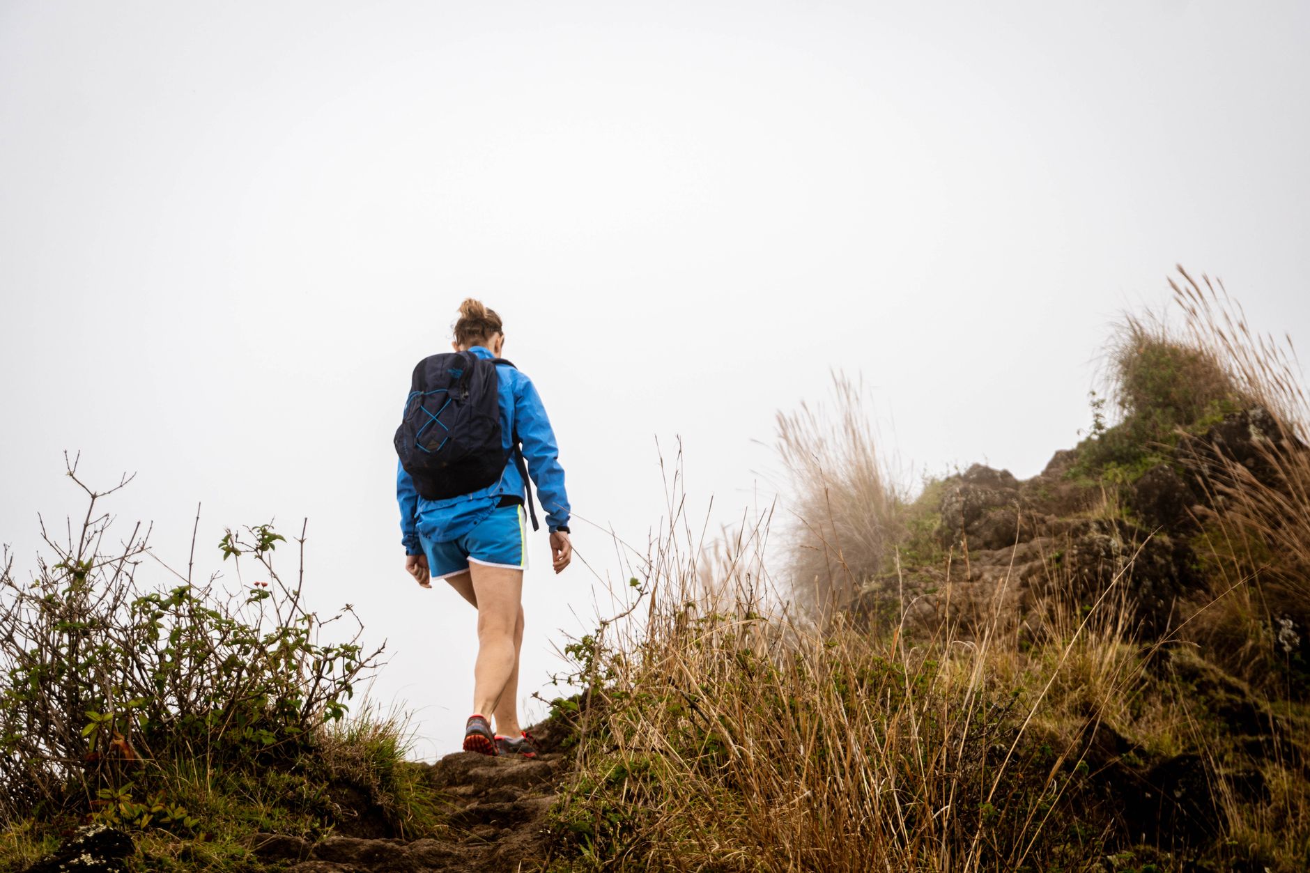 solo woman hiking wilderness trail