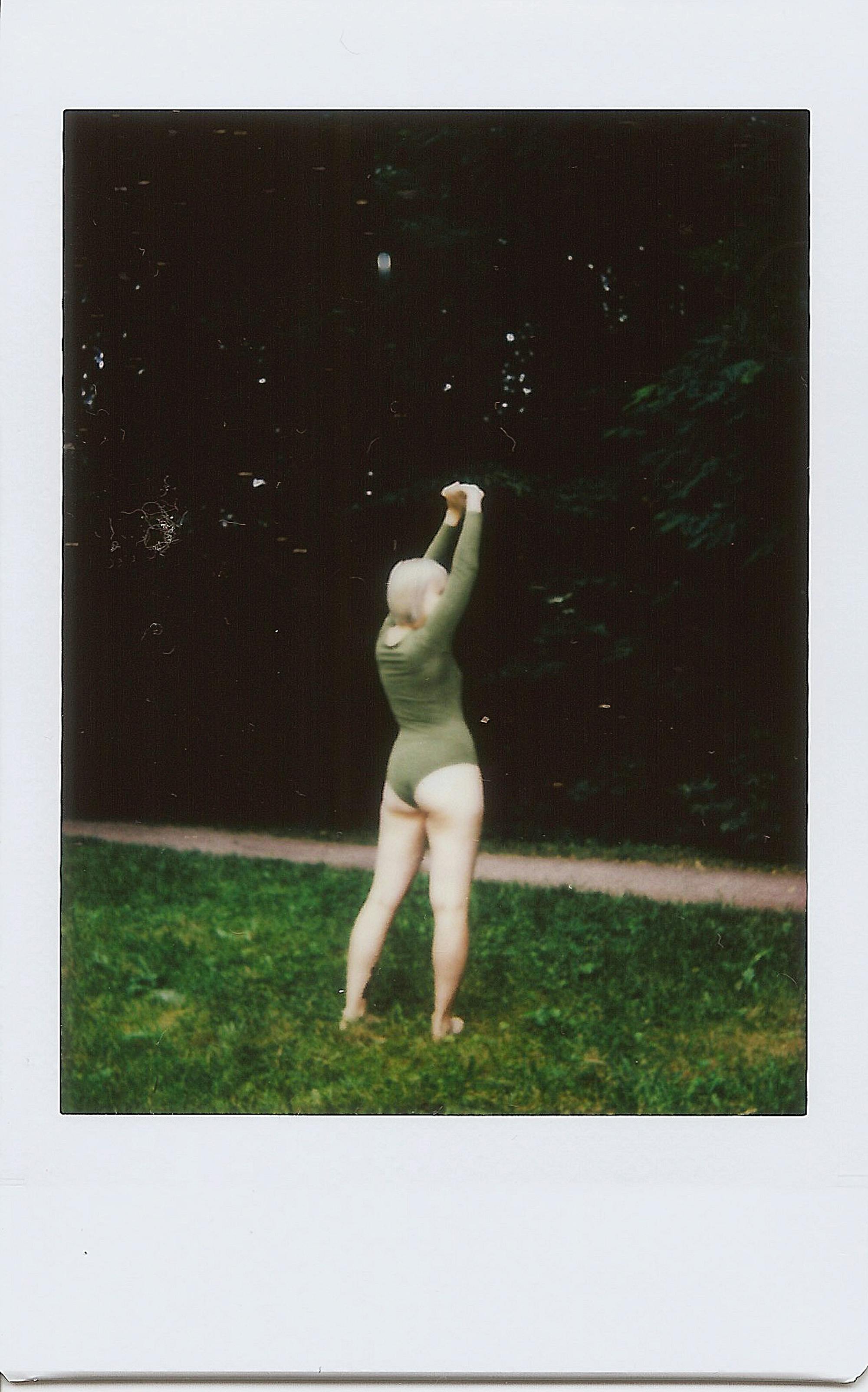 polaroid picture of a woman in a bodysuit