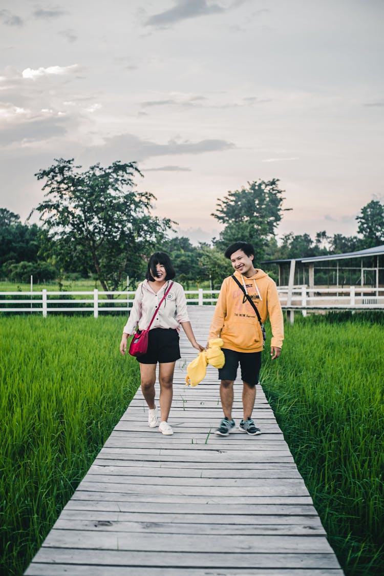 Couple Walking Down The Boardwalk 