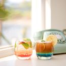 2 Clear Drinking Glasses on White Table