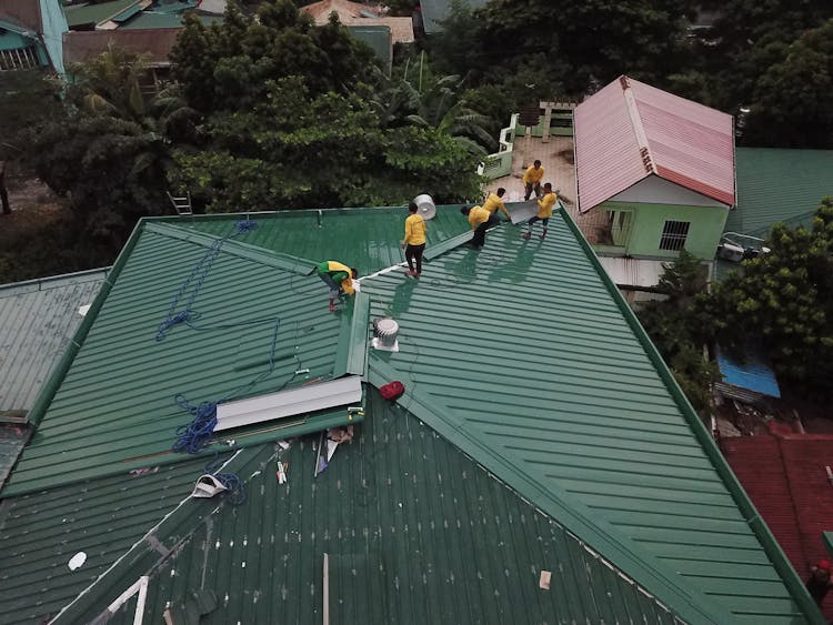 People Working On A House Roof 