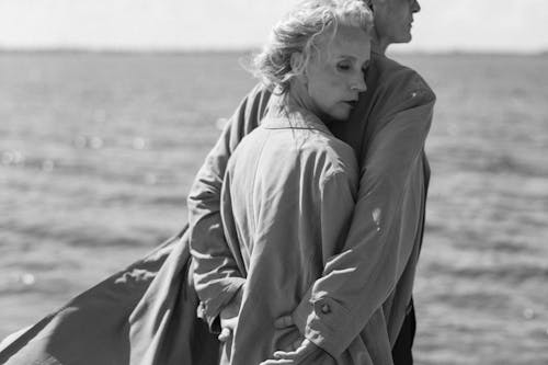Free Grayscale Photo of Two People in Trench Coats Stock Photo