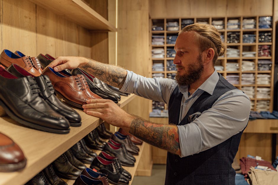 Caucasian man browsing leather shoes in a stylish clothing store. Adult male in trendy fashion setting. Caucasian man browsing leather shoes in a stylish clothing store. Adult male in trendy fashion setting.