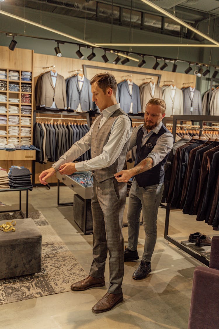 A Male Customer Fitting A Plaid Vest