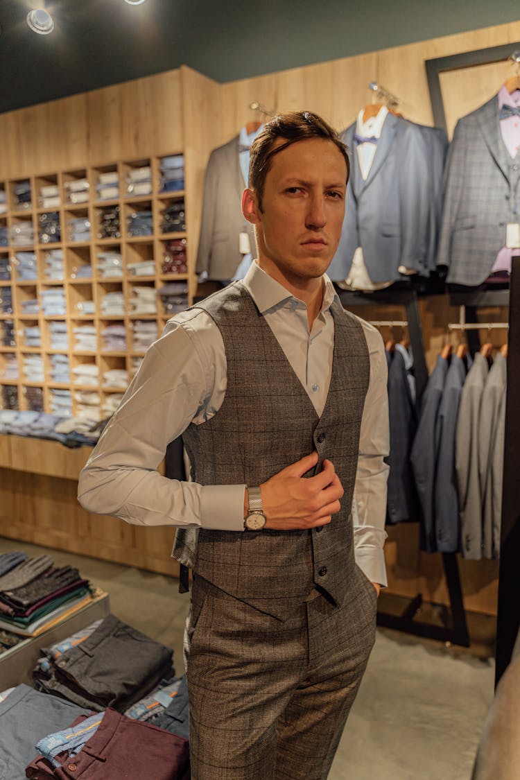 Man In Blue Long Sleeves And Checkered Vest In A Shop