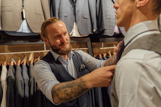 A Bearded Man Fixing a Client's Necktie