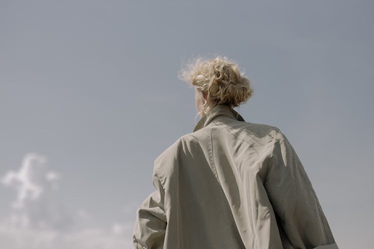 Low Angle Shot Of A Person In A Beige Coat