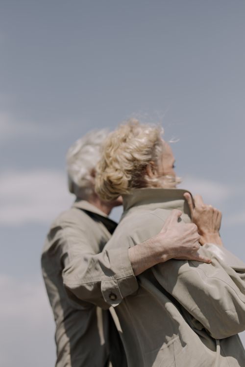 A senior couple embracing affectionately outdoors