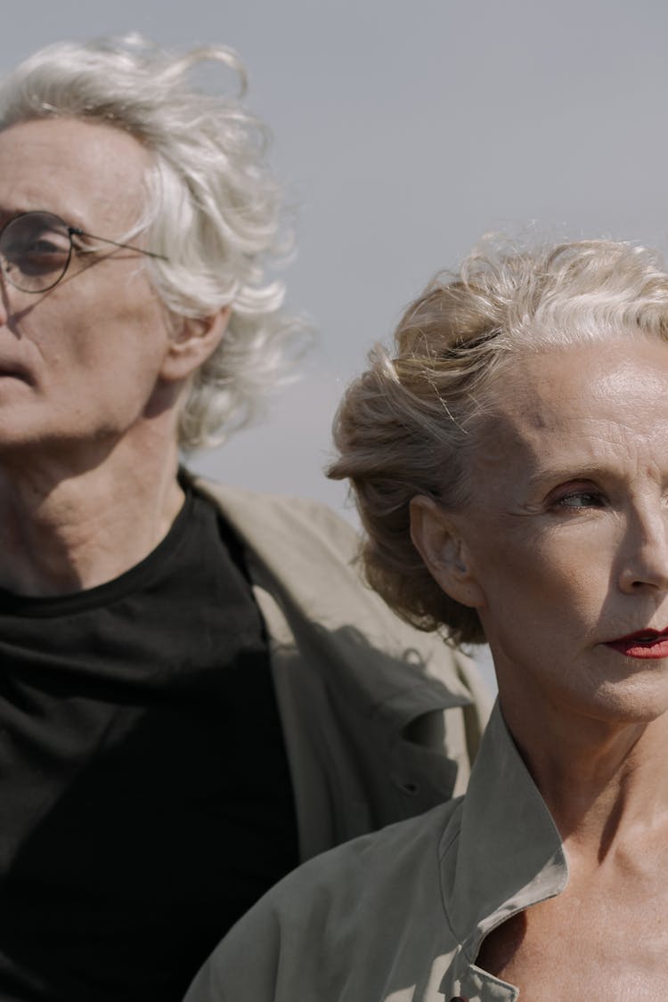 Gray Haired Man And Woman Looking Away 