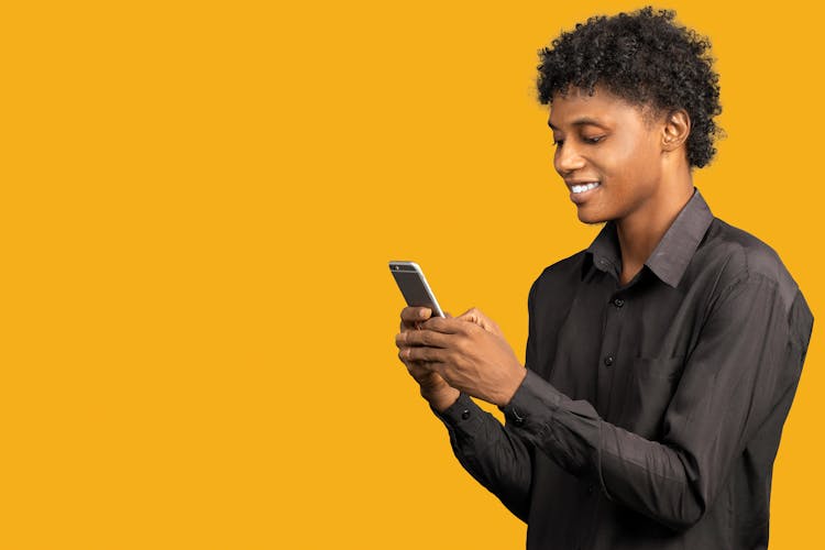 Man In A Black Shirt Against Yellow Background