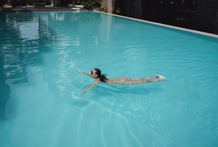 Pretty Woman Swimming In Pool In Resort