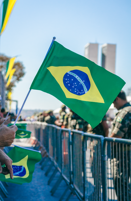 Brazilian flags waving during a military event in Brasília, capturing national pride.