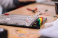 Gray and Black Rectangular Device on White and Brown Table