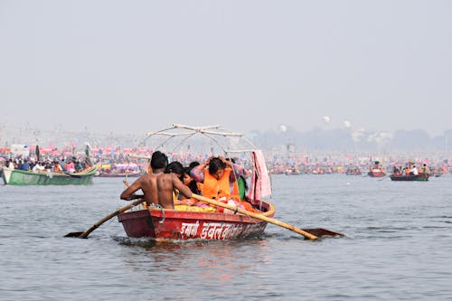 Free People Riding in a Boat in the Ganges River Stock Photo