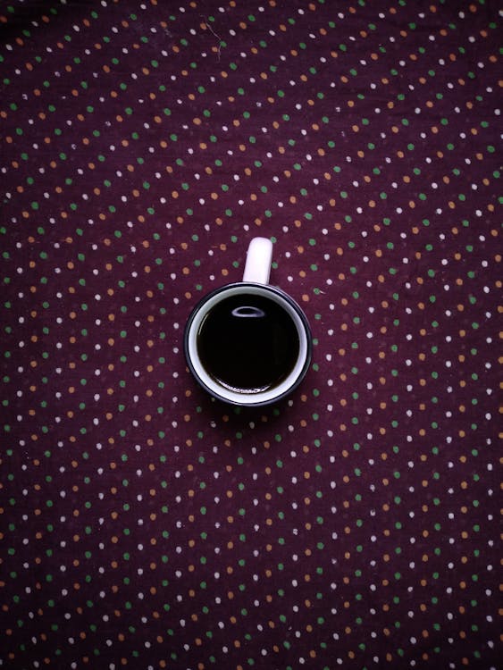 Free Mug on a Polka Dot Textile Stock Photo
