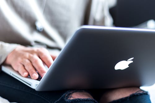 Free Person Using Silver Macbook Stock Photo