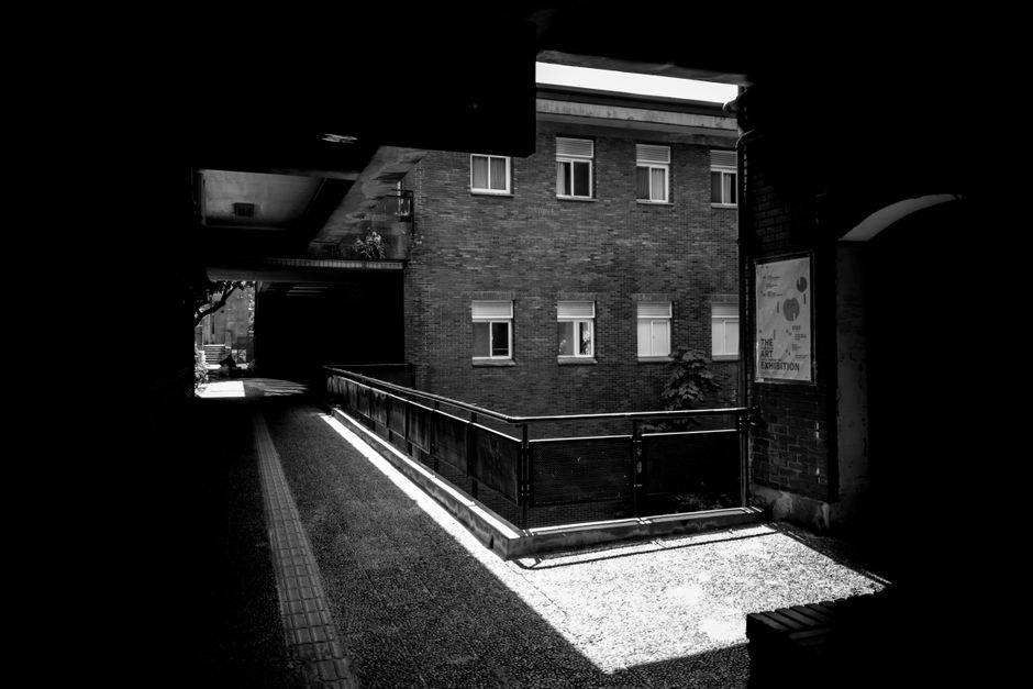 Grayscale image of urban architecture in a Taiwanese alleyway.