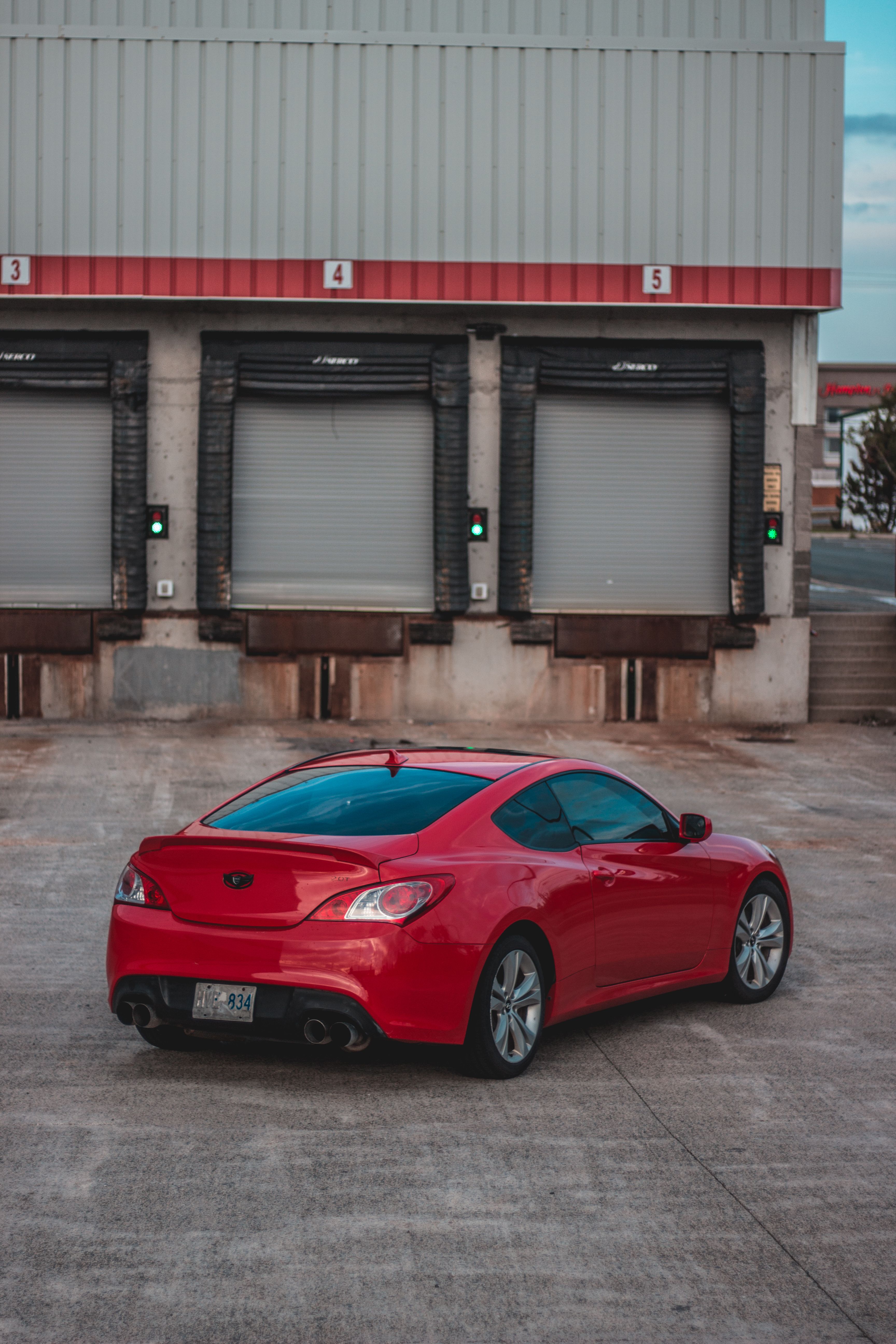 A Red Sedan Car Parked on the Road · Free Stock Photo