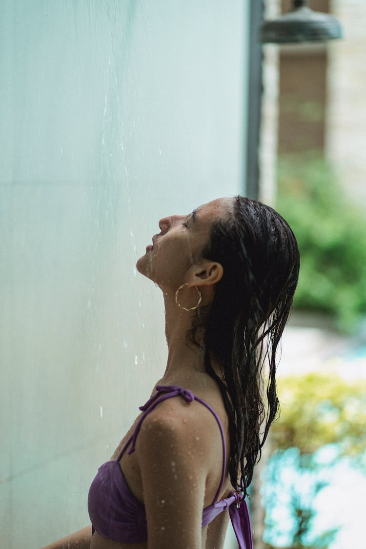 Young Female With Wet Hair Relaxing In Shower