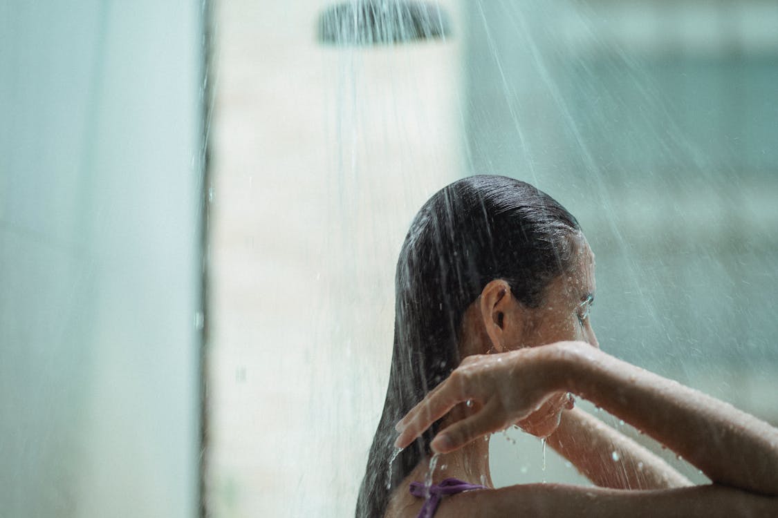 Calm woman washing in shower