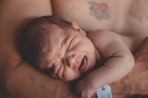 Topless Man Carrying a Baby