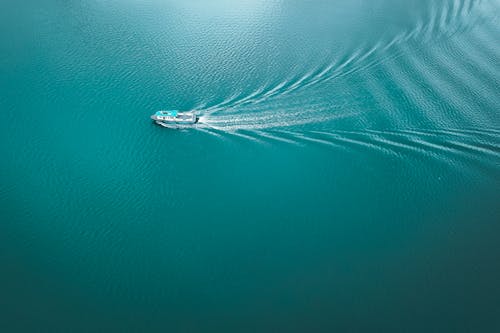 Free From above of modern motorboat floating in calm turquoise sea in sunny day Stock Photo