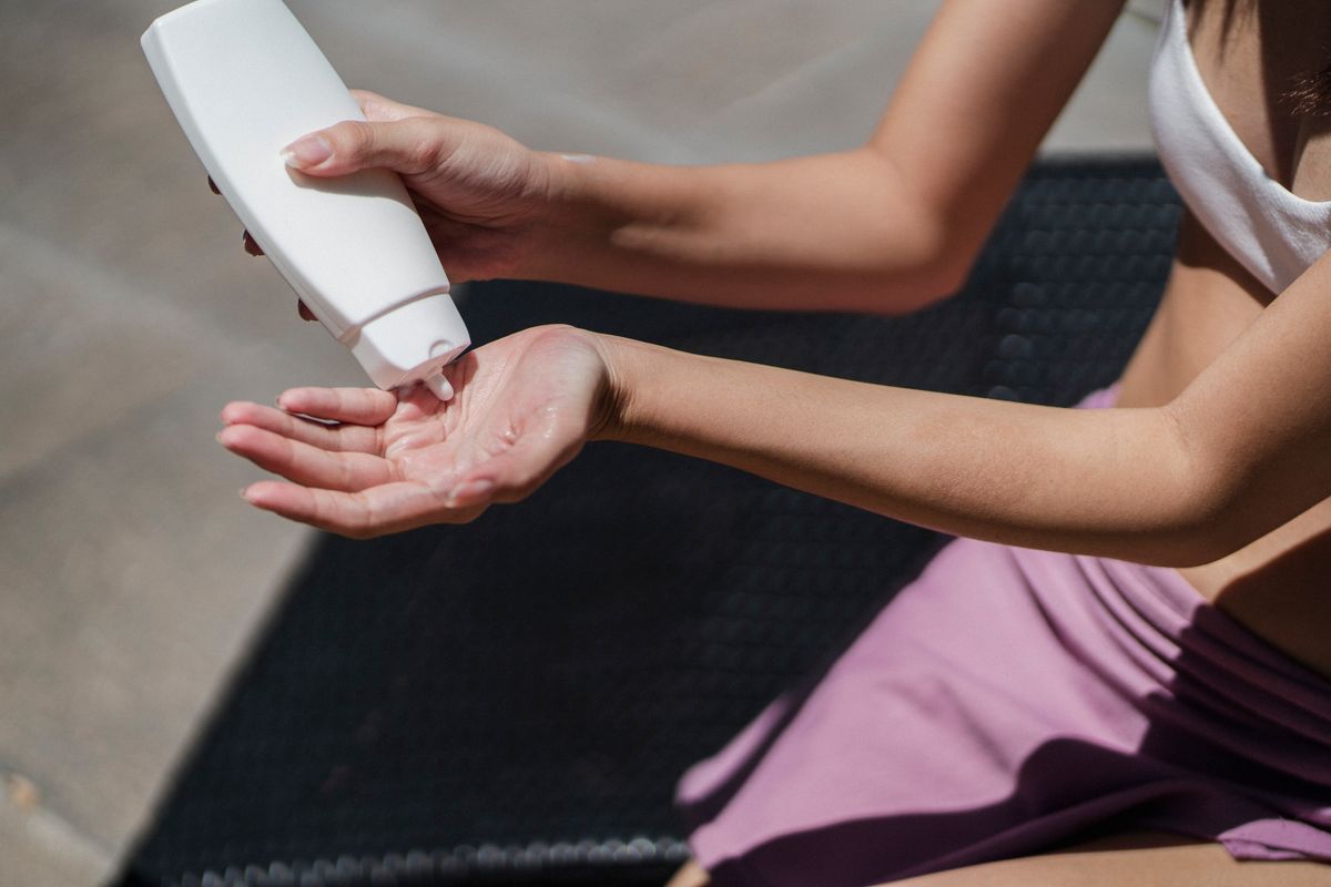 Close-up of SPF sunscreen being applied to the hand on a sunny day