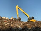 Yellow Excavator on a Pile of Trash