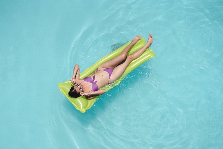 Relaxed Woman Floating In Pool