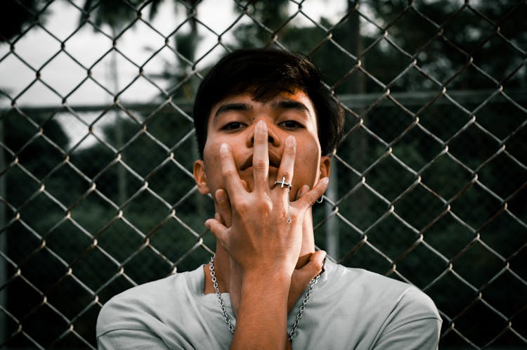 Indian Man Standing Near Fence