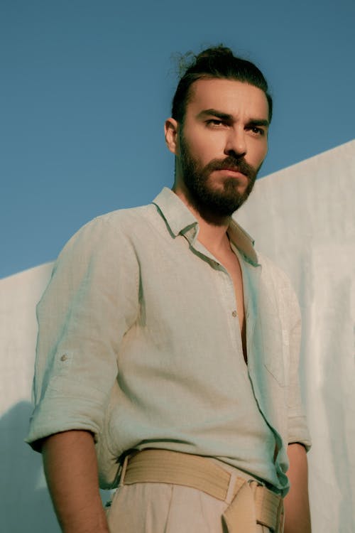 Confident man standing near sheet