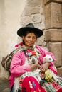 Woman in Pink Long Sleeve Shirt Carrying White Puppy