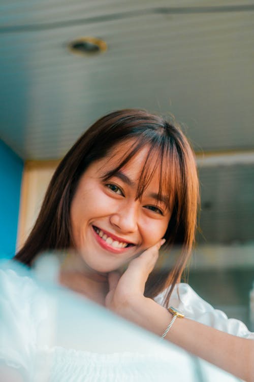 Happy Asian woman on balcony