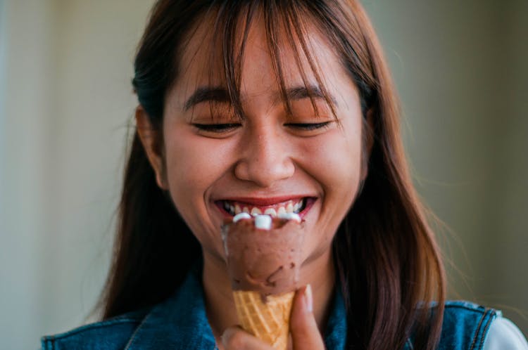 Cheerful Asian Woman With Ice Cream