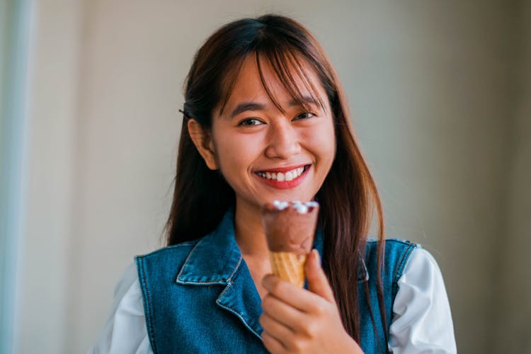 Delighted Asian Woman With Ice Cream Cone