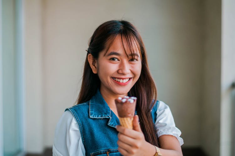 Smiling Asian Woman With Chocolate Ice Cream