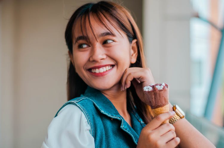 Delighted Asian Woman With Ice Cream