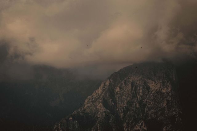 Rocky peaks in heavy fog on an overcast day — photo by Francesco Ungaro on Pexels
