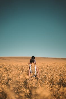 Photographer standing in a yellow flower field in Cape Town, capturing the beauty of nature.