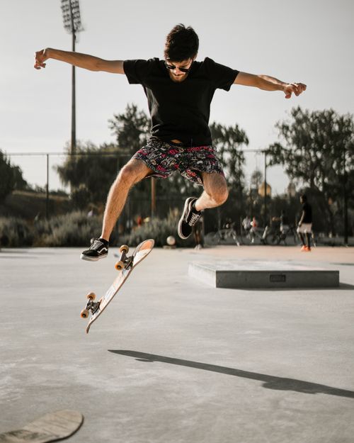 Free Dynamic shot of a skateboarder in mid-air at a skate park in Aveiro, Portugal. Stock Photo