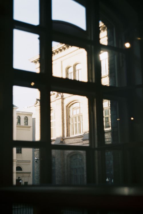 Free View of a historic building captured through a window reflection, showcasing architecture. Stock Photo