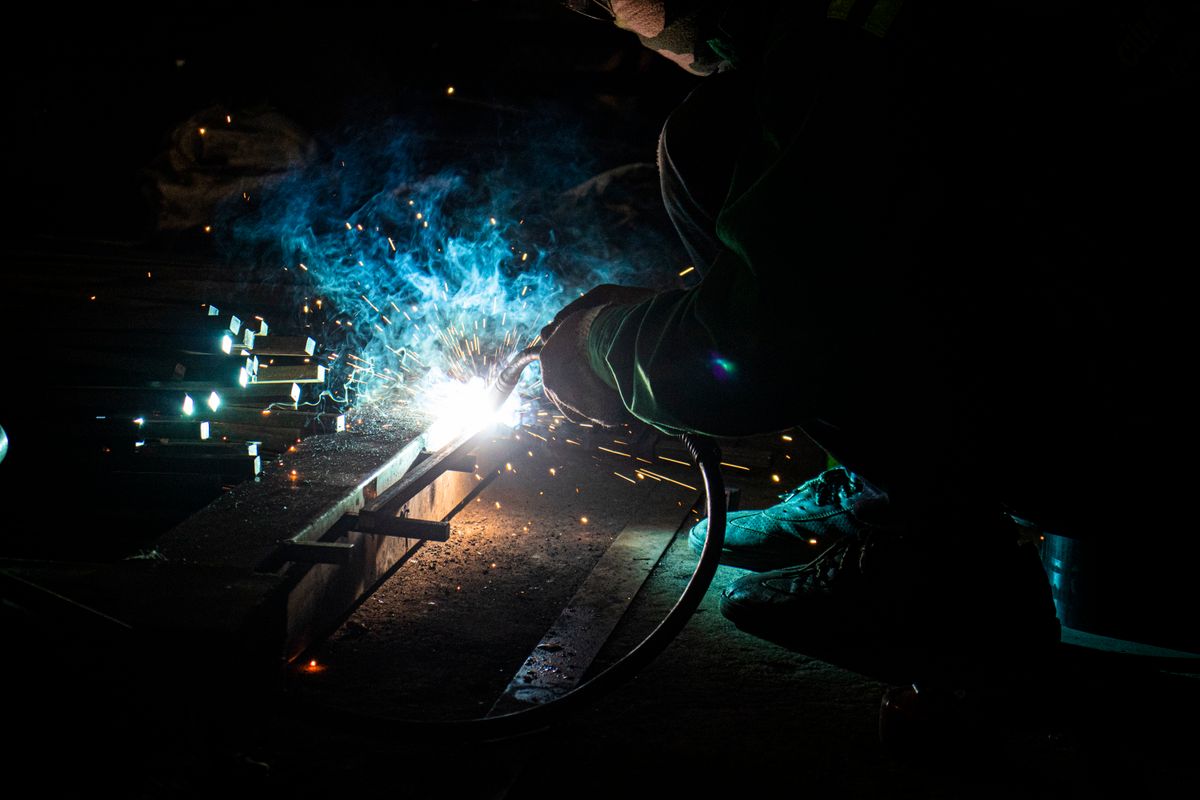Welder at work with sparks