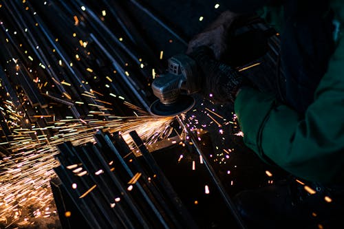 A Person Grinding a Metal