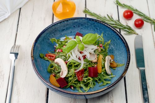 Free A vibrant vegetable salad with organic greens, mushrooms, and fresh herbs served in a blue bowl. Stock Photo